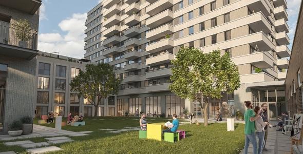 Impressie van TAC living, met twee appartement gebouwen en een grasveld