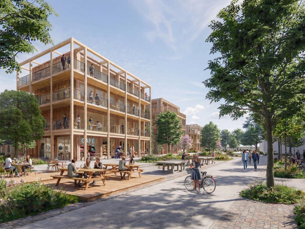 Impressie van het plein, met zicht op woningen en een café. (Foto: VenhoevenCS Architectuur + Stedenbouw)